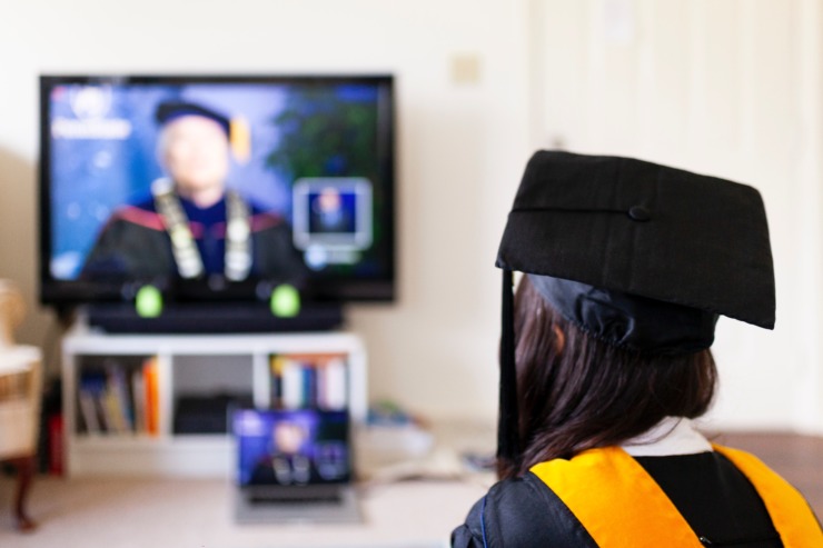 A woman takes part in a virtual graduation ceremony.