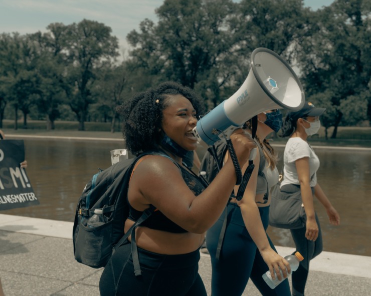 A woman marches with a megaphone at a Black Lives Matter protest.