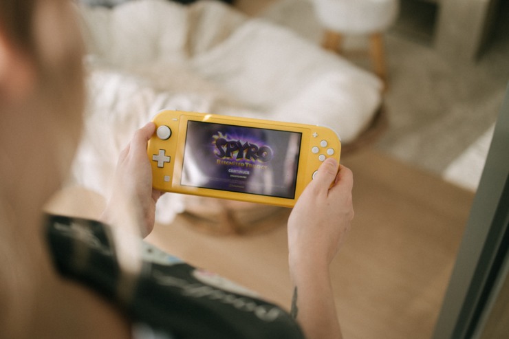 A gen Z gamer uses a handheld console