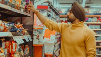 Man browses a supermarket shelf