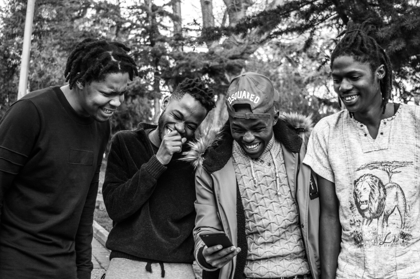 A group of Gen Zs laughing at a phone