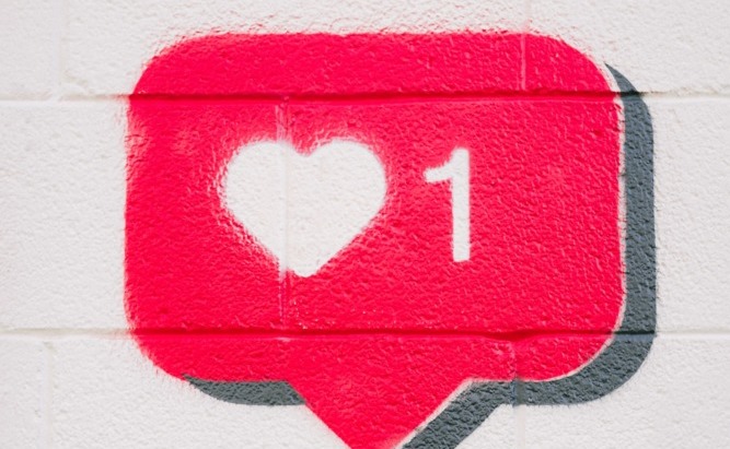 Instagram 'like' button painted on a brick wall
