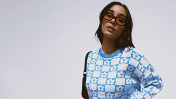 Princess Polly ad - model wearing blue checked jumper and sunglasses