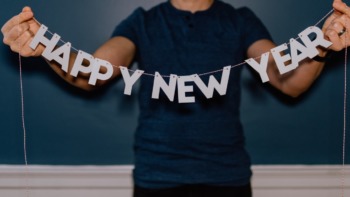 Person holding up a new year banner