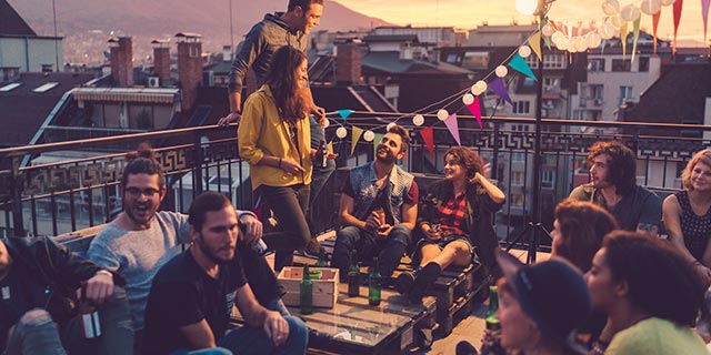 Group of young people enjoying a roof top social gathering