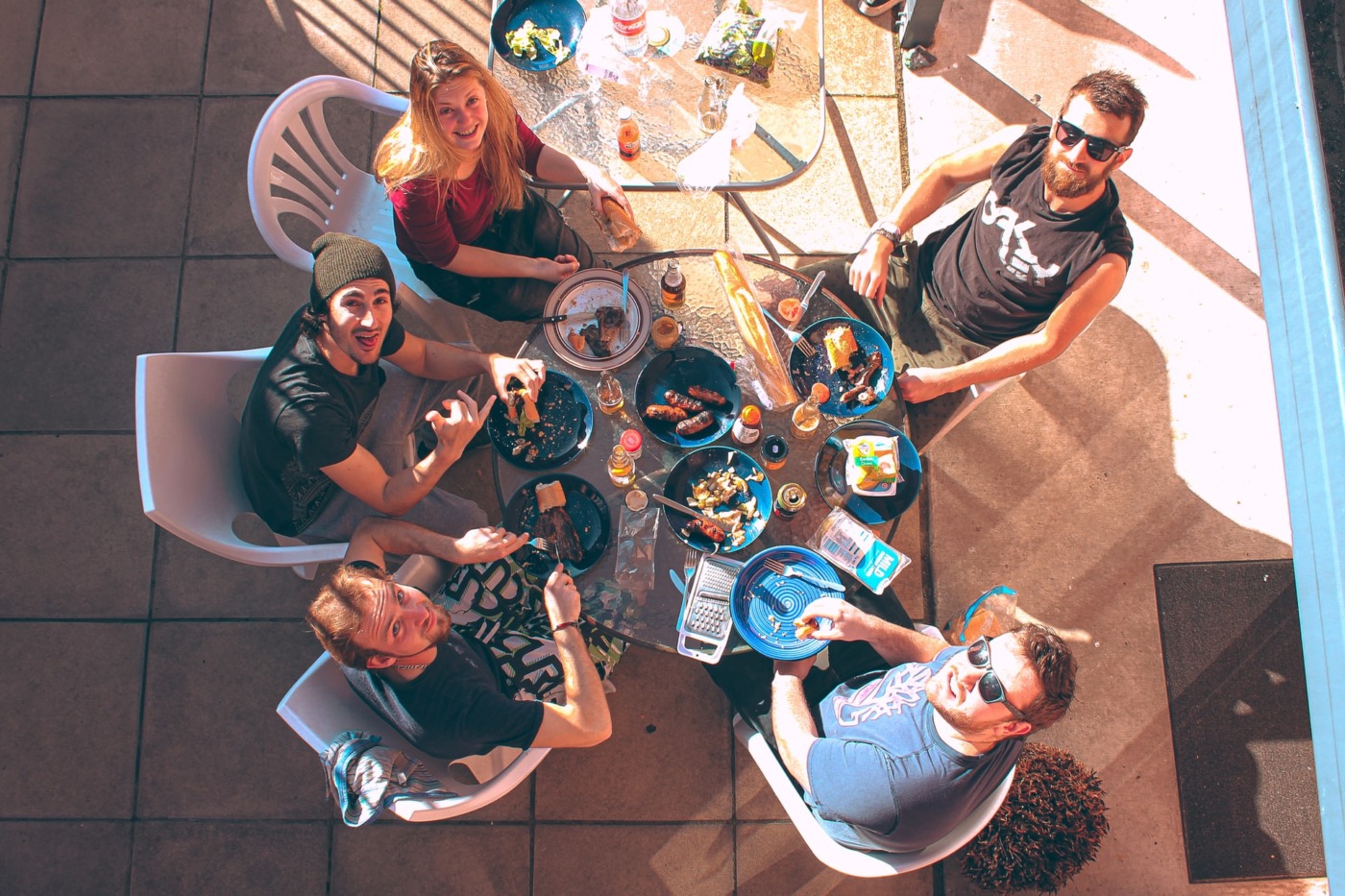 Group of friends having a BBQ outside in the sun