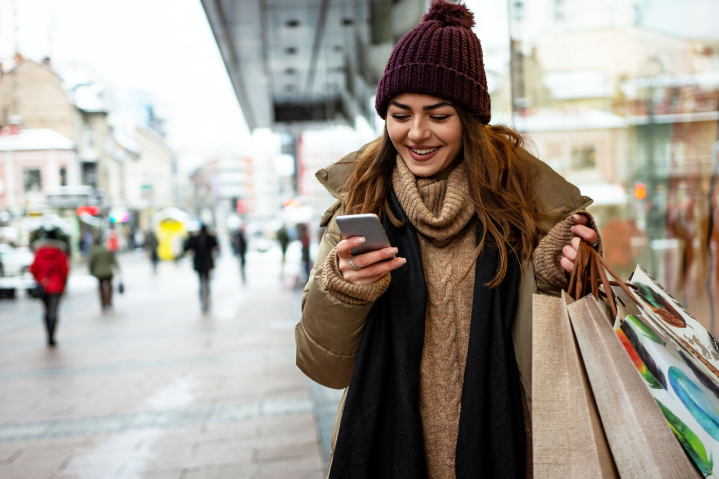 Young Gen Z woman using her mobile phone and shopping