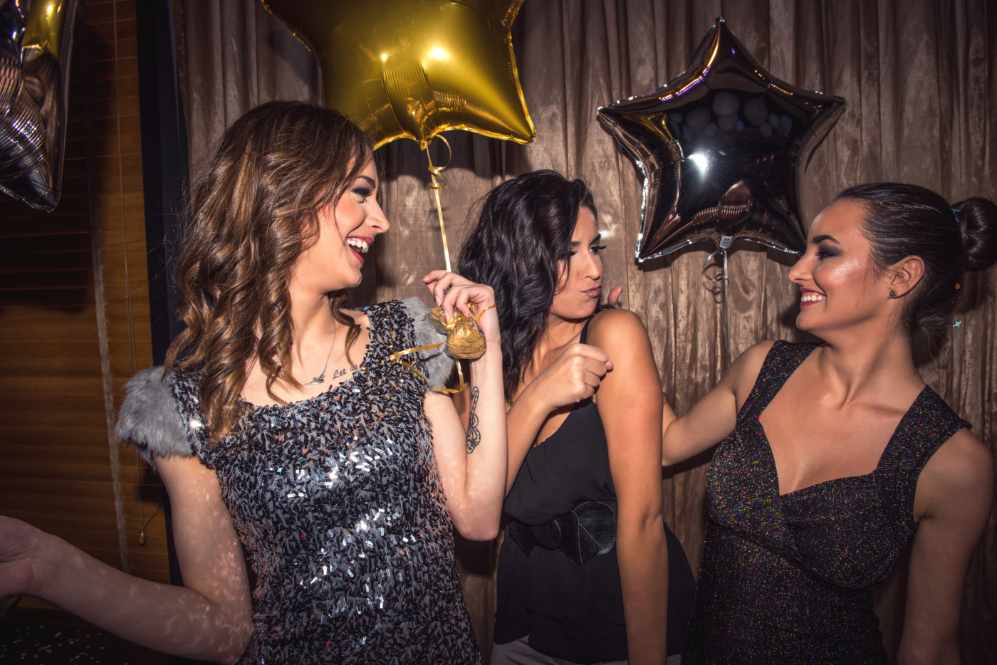 Three teenage girls partying in a club.